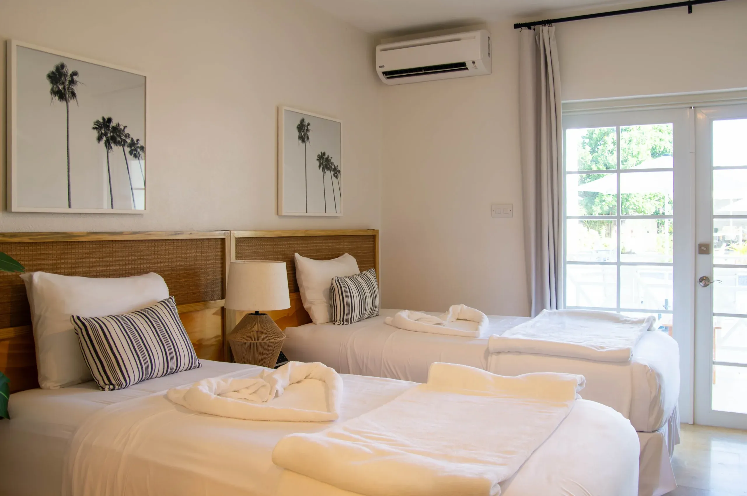 Pool View Two Twin room at South Point Hotel Barbados featuring two twin beds, natural light, and tropical décor.