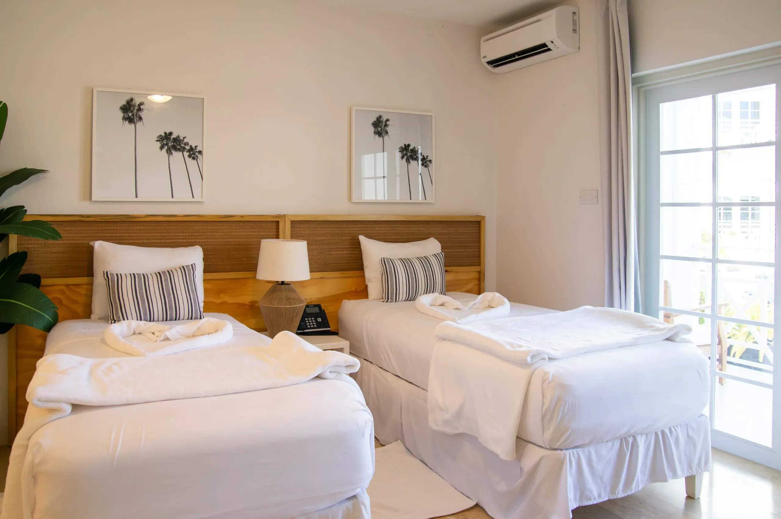 Pool View Two Twin room at South Point Hotel Barbados featuring two twin beds, natural light, and tropical décor.